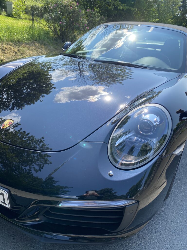 Immaculate exterior treatment for Uni Black Porsche Targa, followed by thorough interior cleaning, polishing, and wax sealing.